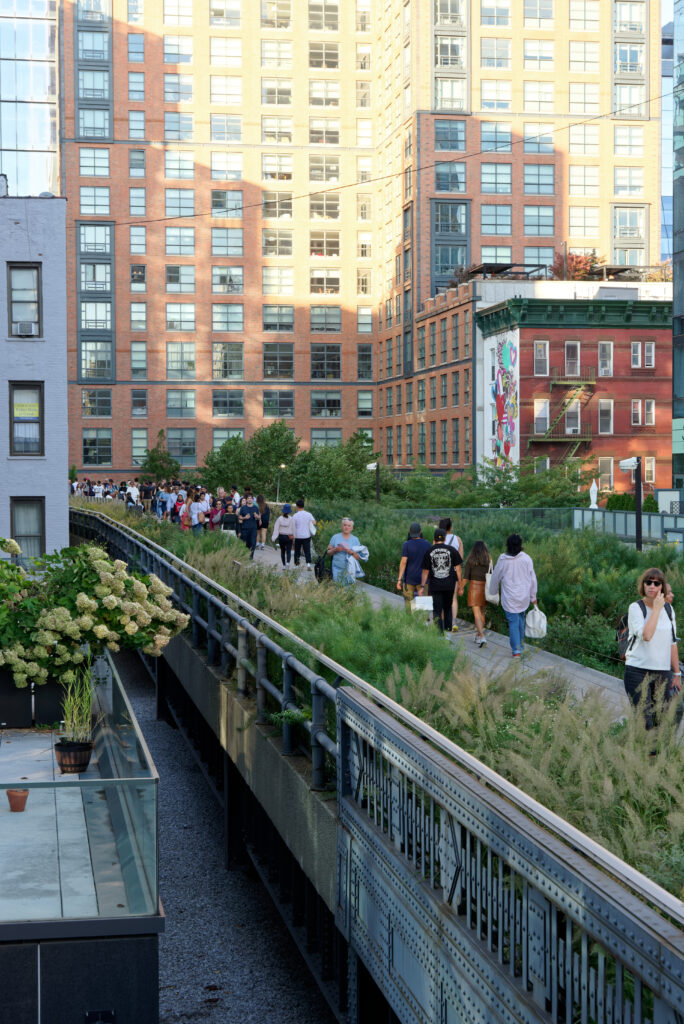 High Line access: planted walkway with visitors in Manhattan